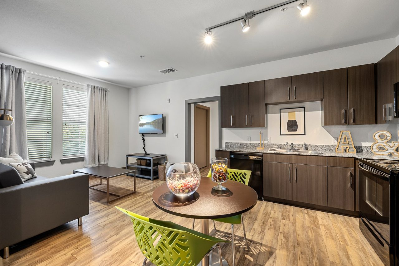 holleman crossing apartments near texas am kitchen dining and living room space