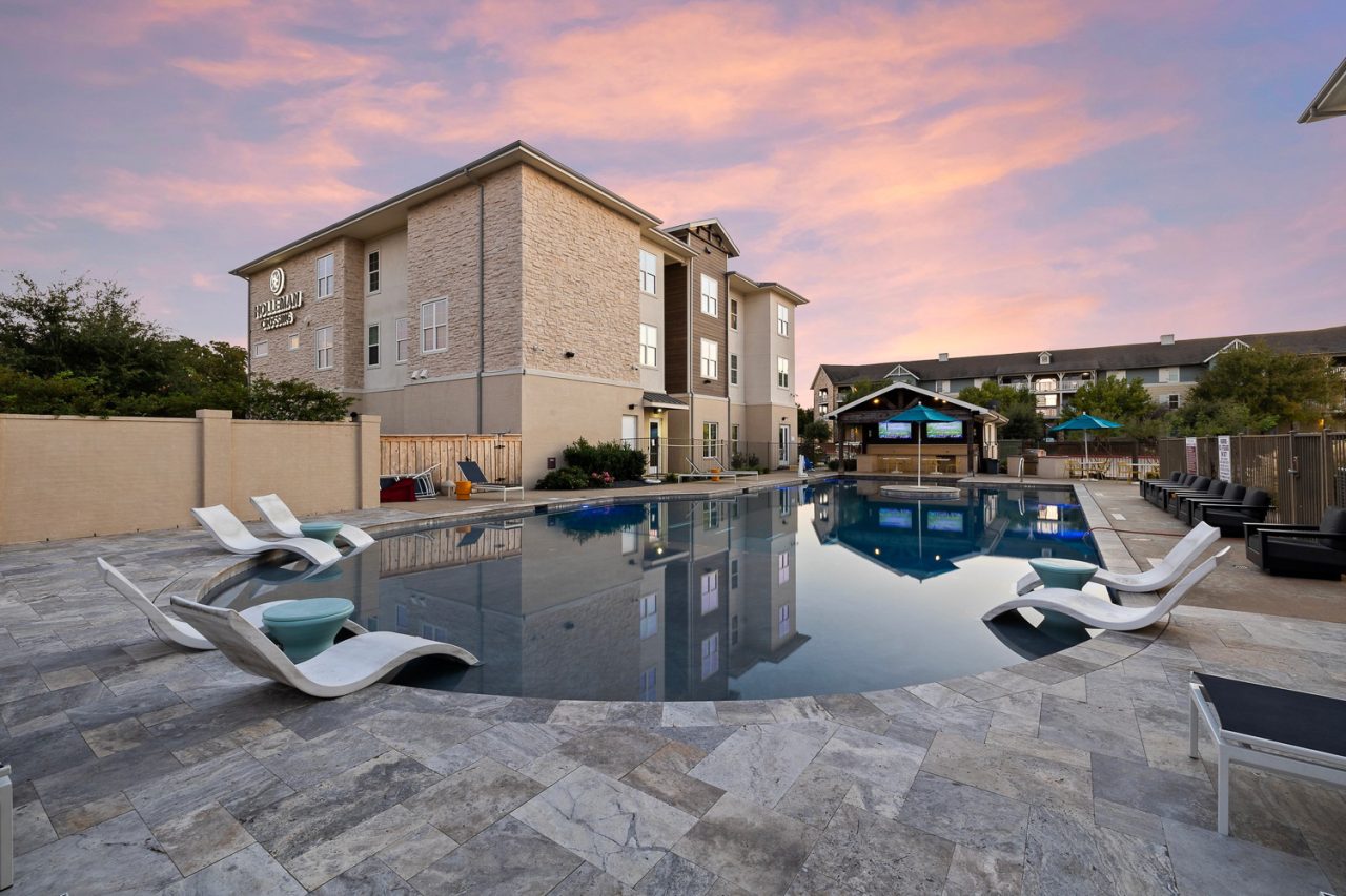 holleman crossing apartments near texas am pool and outdoor lounge cabana at sunset